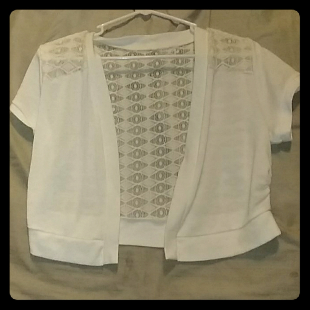 White cardigan with a lacey back.